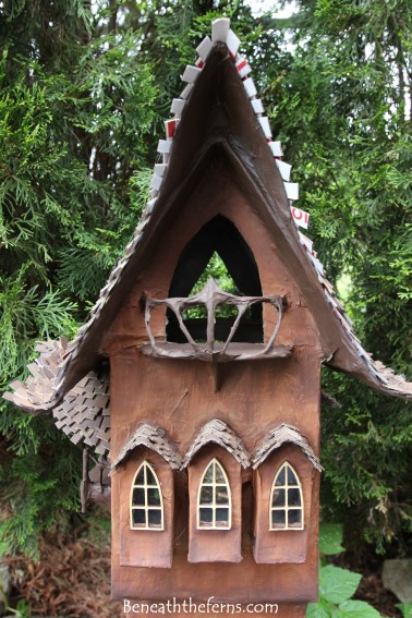 Fairy gardens house miniature scale tower by beneath the ferns close up front
