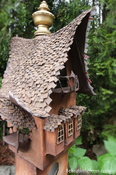 Fairy gardens house miniature scale tower by beneath the ferns close up