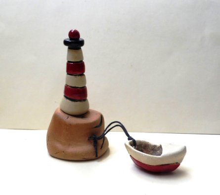 Miniature lighthouse and boat by Ednapio